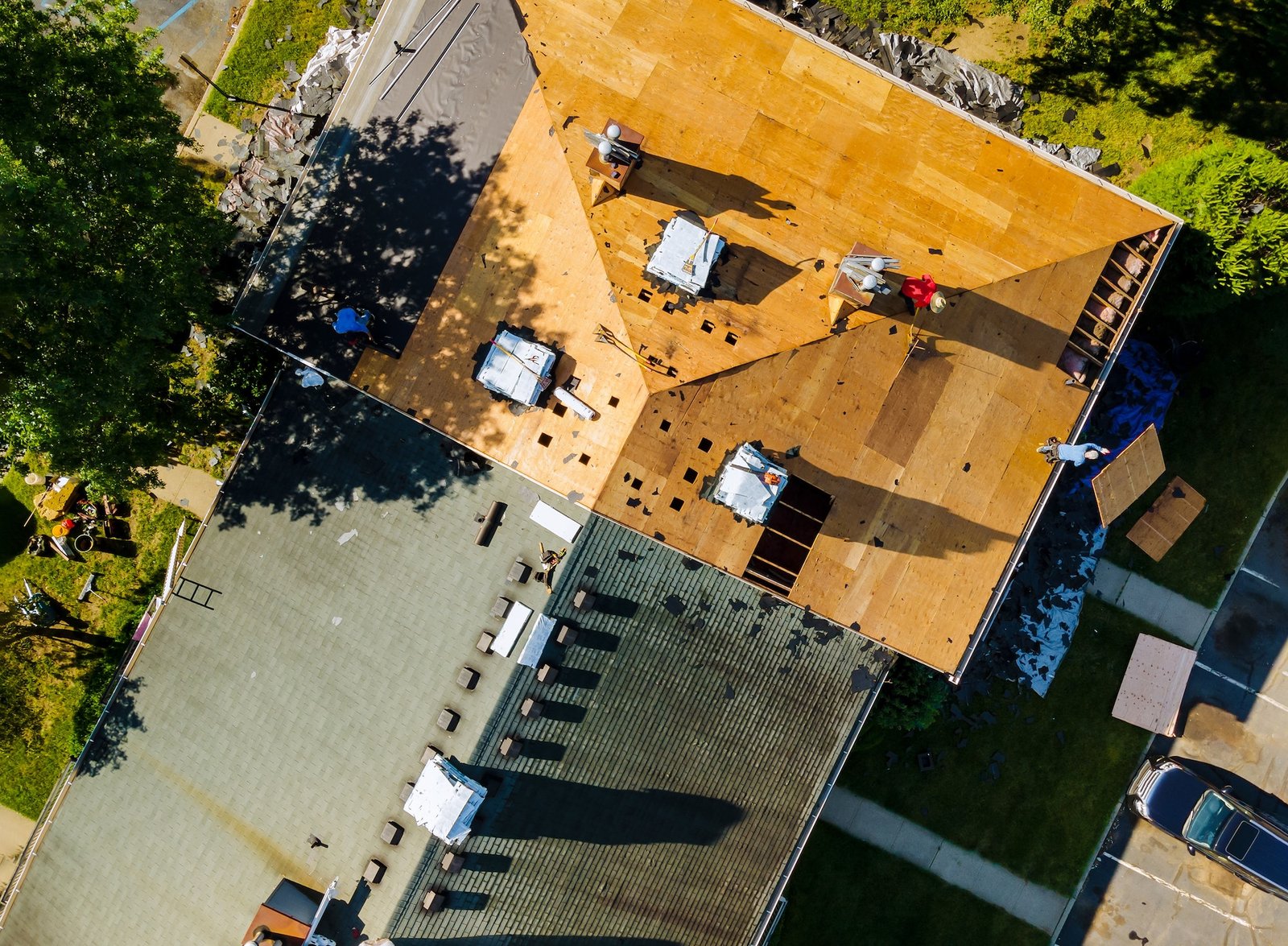 Roof shingles need with new shingles of an apartment building replacing a gray asphalt tile